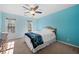 Bedroom featuring light blue walls, queen bed and ceiling fan at 3330 Arborwoods Dr, Alpharetta, GA 30022