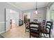 Formal dining room features a decorative chandelier and hardwood floors at 3330 Arborwoods Dr, Alpharetta, GA 30022