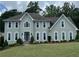 Elegant two-story house featuring symmetrical windows, stone steps, and a well-manicured lawn at 3330 Arborwoods Dr, Alpharetta, GA 30022