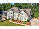 Charming two-story home featuring a manicured lawn, tasteful landscaping, and a welcoming, curved walkway at 3330 Arborwoods Dr, Alpharetta, GA 30022
