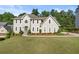 Well-manicured lawn and landscaping frame this inviting two-story traditional style home at 3330 Arborwoods Dr, Alpharetta, GA 30022