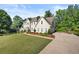 Well-manicured front yard and two-story home with a long driveway at 3330 Arborwoods Dr, Alpharetta, GA 30022