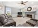 Bright living room with a fireplace, large windows, and plush seating at 3330 Arborwoods Dr, Alpharetta, GA 30022