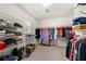 Well-organized walk-in closet with shelving and hanging racks for clothing and accessories at 3330 Arborwoods Dr, Alpharetta, GA 30022