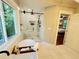 A bright bathroom includes a soaking tub, glass enclosed shower and view to wooded backyard at 3820 Fox Creek Ct, Marietta, GA 30062