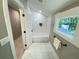 A small bathroom includes a white tiled shower/tub combination and a view to wooded backyard at 3820 Fox Creek Ct, Marietta, GA 30062