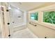 Bathroom featuring a soaking tub, subway tile, and a bright window with natural light at 3820 Fox Creek Ct, Marietta, GA 30062