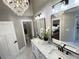 Bright bathroom features double vanity, glass shower, and elegant chandelier at 3820 Fox Creek Ct, Marietta, GA 30062