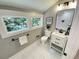 Cozy bathroom with a modern vanity, white tiled floors, and a scenic window view at 3820 Fox Creek Ct, Marietta, GA 30062