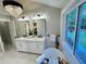 Bright bathroom features double vanity with marble countertop, soaking tub and window view to backyard at 3820 Fox Creek Ct, Marietta, GA 30062