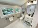 This is a powder room with a white vanity, a white toilet and a view to wooded backyard at 3820 Fox Creek Ct, Marietta, GA 30062