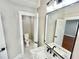 A half bathroom with marble tile floor, modern fixtures, and a view into a bedroom at 3820 Fox Creek Ct, Marietta, GA 30062