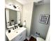 Stylish powder room featuring a modern vanity, decorative mirror and unique lighting at 3820 Fox Creek Ct, Marietta, GA 30062