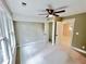 Neutral-colored bedroom with ceiling fan, two windows, and white-painted doors and trim at 3820 Fox Creek Ct, Marietta, GA 30062