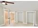 Bright bedroom featuring a ceiling fan, carpet flooring, walk-in closets, and white painted trim at 3820 Fox Creek Ct, Marietta, GA 30062