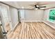 Large bedroom with wood floors and bright windows overlooking a wooded area at 3820 Fox Creek Ct, Marietta, GA 30062