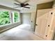 Neutral-colored bedroom with ceiling fan, two windows, and white-painted doors and trim at 3820 Fox Creek Ct, Marietta, GA 30062