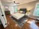 Inviting bedroom with a plush bed, hardwood floors, and natural light from the windows at 3820 Fox Creek Ct, Marietta, GA 30062