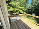 Exterior view of wooden deck with metal railing overlooking the backyard trees at 3820 Fox Creek Ct, Marietta, GA 30062
