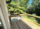 A wooden deck with black metal railings with a view of the forest at 3820 Fox Creek Ct, Marietta, GA 30062
