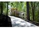A charming two-story home with a long concrete driveway surrounded by lush greenery at 3820 Fox Creek Ct, Marietta, GA 30062