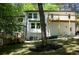 Rear exterior showcasing a wooden deck, lower level access, and green surroundings at 3820 Fox Creek Ct, Marietta, GA 30062