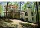 Exterior of a home featuring a deck, large windows, and beautiful landscaping at 3820 Fox Creek Ct, Marietta, GA 30062