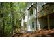 Exterior of home with decks, many windows, and lush trees at 3820 Fox Creek Ct, Marietta, GA 30062
