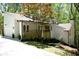 Charming home exterior with a wood deck, black trim, and manicured landscaping at 3820 Fox Creek Ct, Marietta, GA 30062