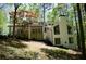 Stylish home with a light exterior, a wood deck, and tall chimney at 3820 Fox Creek Ct, Marietta, GA 30062