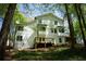Exterior of the home showing a back deck, stone foundation, and mature trees at 3820 Fox Creek Ct, Marietta, GA 30062