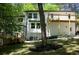 Home exterior with wooden deck, well-maintained lawn, and mature trees at 3820 Fox Creek Ct, Marietta, GA 30062