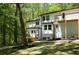 Exterior of home showcasing the side yard, rear deck, and mature trees at 3820 Fox Creek Ct, Marietta, GA 30062