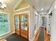 Bright foyer with wood flooring, glass paneled front doors, and hallway views at 3820 Fox Creek Ct, Marietta, GA 30062