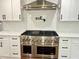 Close-up of a professional-grade ZLINE stainless steel range and vent hood in a modern kitchen at 3820 Fox Creek Ct, Marietta, GA 30062