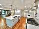 Modern white kitchen with a large island, stainless steel appliances, and hardwood floors at 3820 Fox Creek Ct, Marietta, GA 30062
