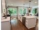 Bright kitchen features a large island with a stainless steel dishwasher, sink, and wooden floor at 3820 Fox Creek Ct, Marietta, GA 30062