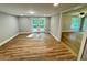 Open-concept living area with modern lighting, a door to the deck, and new flooring at 3820 Fox Creek Ct, Marietta, GA 30062