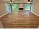 Open living area with wood floors, fireplace, and large windows showcasing the backyard at 3820 Fox Creek Ct, Marietta, GA 30062