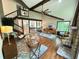 Open living room showcasing hardwood floors, exposed beams, and a stone fireplace at 3820 Fox Creek Ct, Marietta, GA 30062