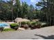 A stunning community pool area featuring a large in-ground pool, comfortable lounge chairs, and lush landscaping at 3820 Fox Creek Ct, Marietta, GA 30062