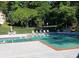 An inviting community pool with lounge chairs and tables with umbrellas, providing a relaxing outdoor space at 3820 Fox Creek Ct, Marietta, GA 30062