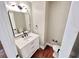 Stylish powder room with modern vanity, black fixtures, and hardwood floors at 3820 Fox Creek Ct, Marietta, GA 30062