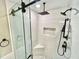 The frameless shower stall offers sleek black hardware and mosaic tile flooring at 3820 Fox Creek Ct, Marietta, GA 30062