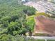 A high-angle view of a house in a lush, green area, with data center construction nearby at 4682 Stonewall Tell Rd, College Park, GA 30349