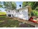Exterior side view of a white home with a set of stairs and a view of the yard at 4682 Stonewall Tell Rd, College Park, GA 30349