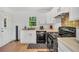 Functional kitchen with white cabinets, black appliances, and ample counter space at 4682 Stonewall Tell Rd, College Park, GA 30349