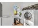 Clean laundry room featuring modern washer and dryer units, with convenient additional freezer space at 4682 Stonewall Tell Rd, College Park, GA 30349