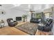 Inviting living room with leather seating, a large rug, and a view of the backyard at 4682 Stonewall Tell Rd, College Park, GA 30349