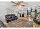 Bright living room featuring a large rug, hardwood floors, and an open view to the kitchen at 4682 Stonewall Tell Rd, College Park, GA 30349